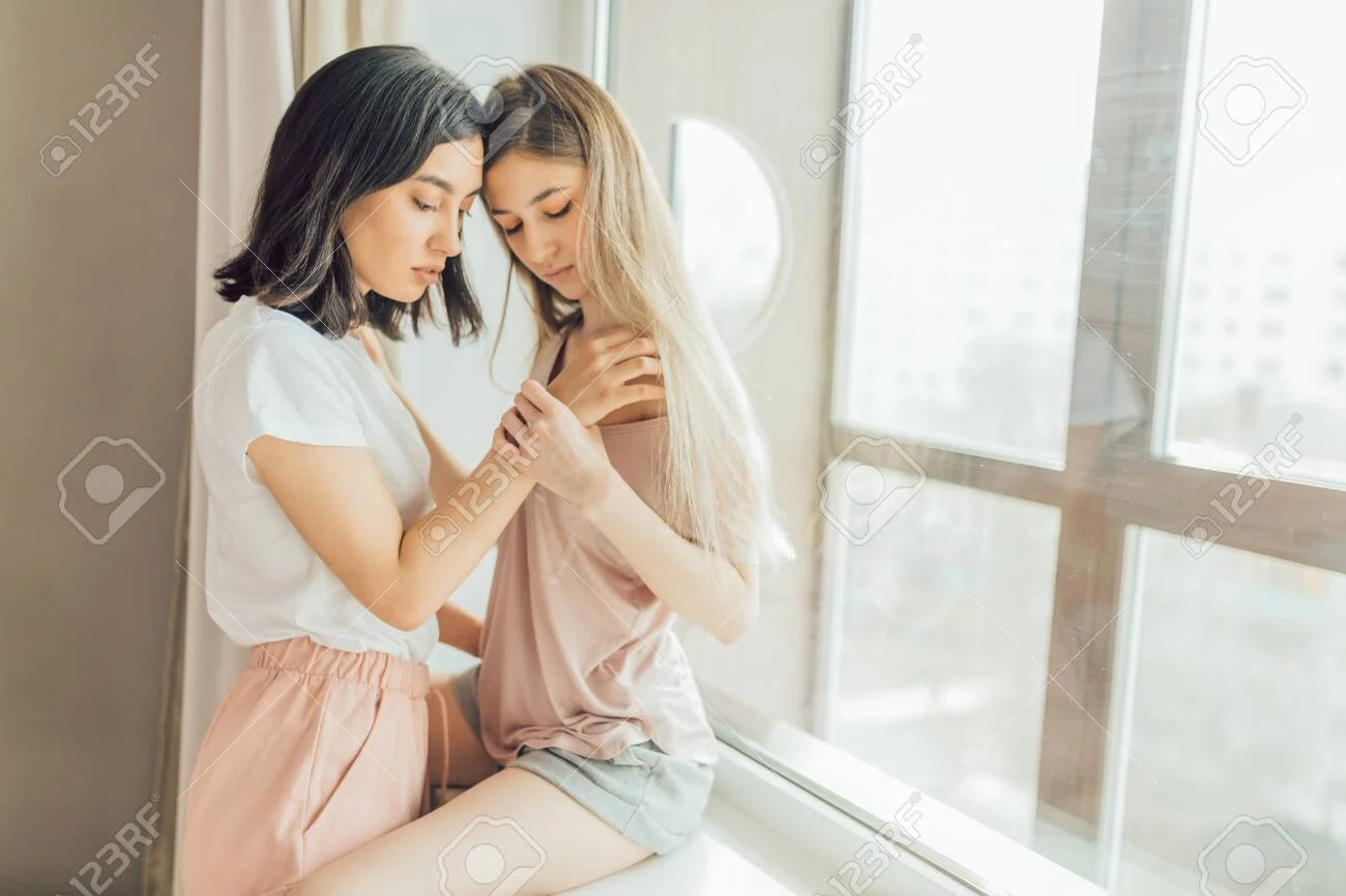 Two Lesbians Making Love Indoors. Close Up Photo. Copy Space. Sexual Behavior Concept. Females Going To Have Sex. Woman Holding A Shoulder Of Other One Stock